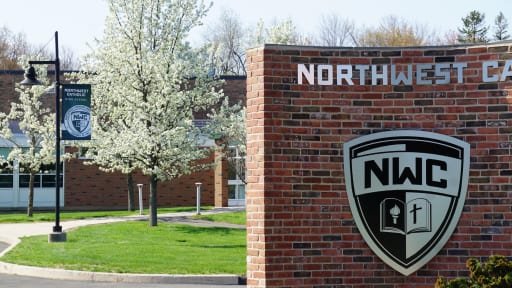 Northwest Catholic school shield on school entrance brick wall sign